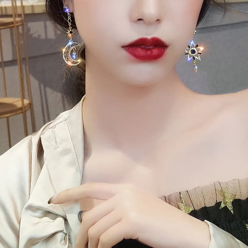 Elegant Silver Asymmetric Star Moon Earrings with Long Tassel Design and Sparkling Detail